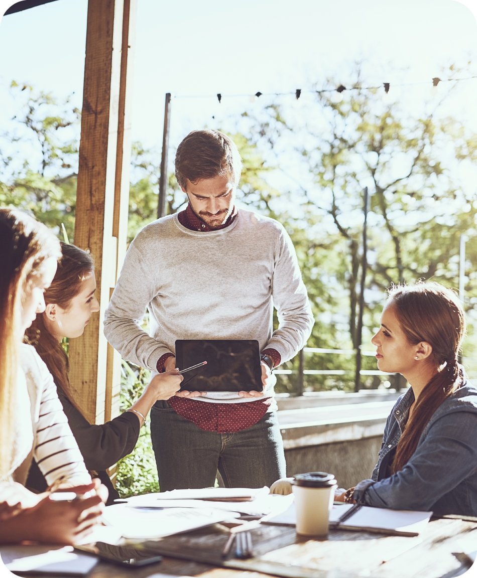 Office workers brainstorming together in an outside setting, relaxed