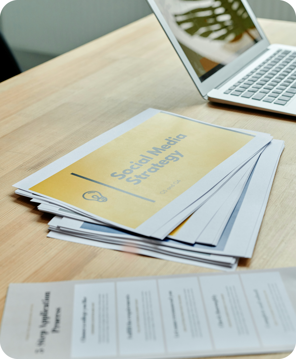 Paperwork on a desk that says social media strategy on it