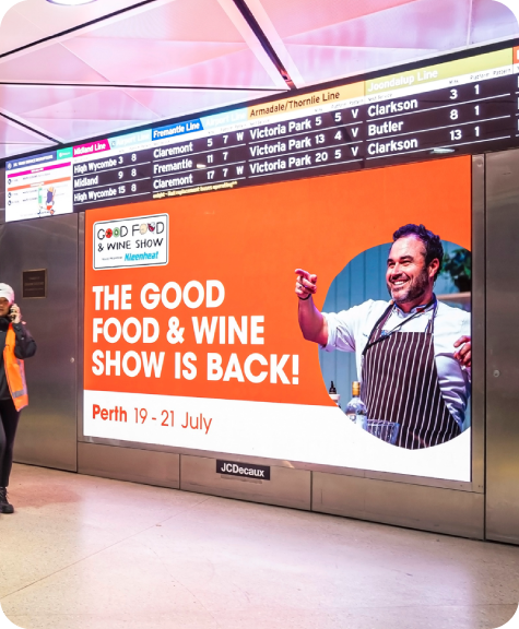A digital billboard showcasing the Good Food and Wine Show's Perth run within a Perth train station