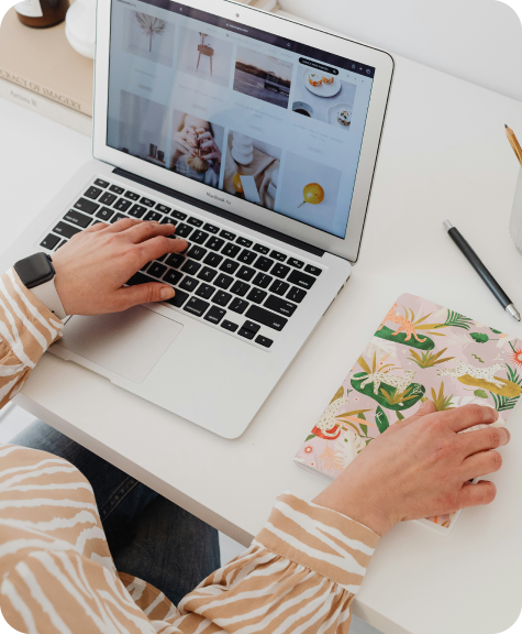 BRI_Blogresizing2_Brand-16 A woman working on a laptop at a desk, with a journal next to her