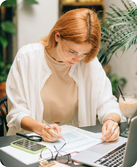 BRI_Blogresizing2_Brand-22 Woman with red hair poring over paperwork and her laptop